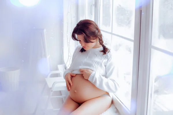 Красивая мягкая и чувственная беременная девушка в белом — стоковое фото
