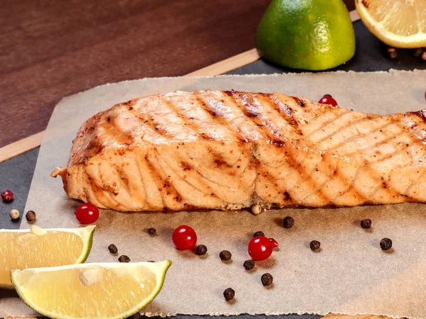 Grilled salmon on coals with lemon on a wooden board. — Stock Image Grilled Salmon Coals Lemon Wooden Board Stock Image