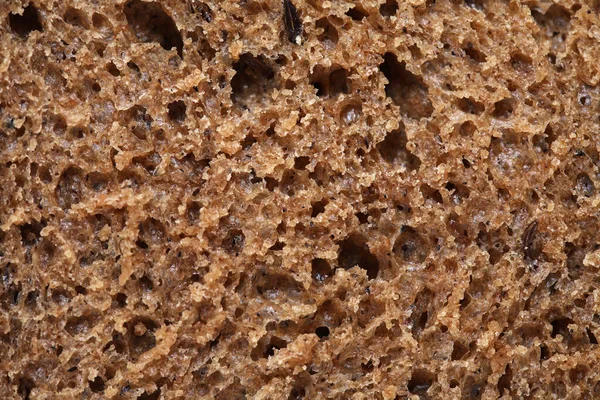 Extreme Nahaufnahme Einer Scheibe Roggenbrot Als Hintergrund Stockbild