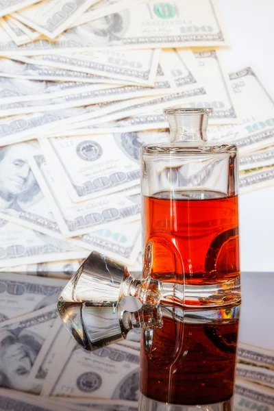 Whiskey bottle and dollars — Stock Photo, Image