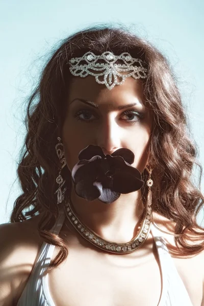 Girl with flower in mouth — Stock Photo, Image