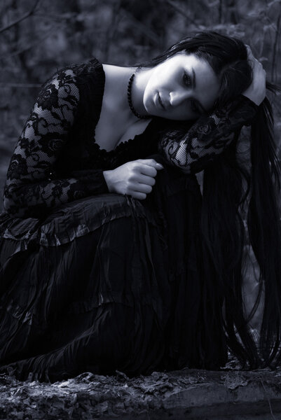 Sad woman in old style black dress. outdoor shot