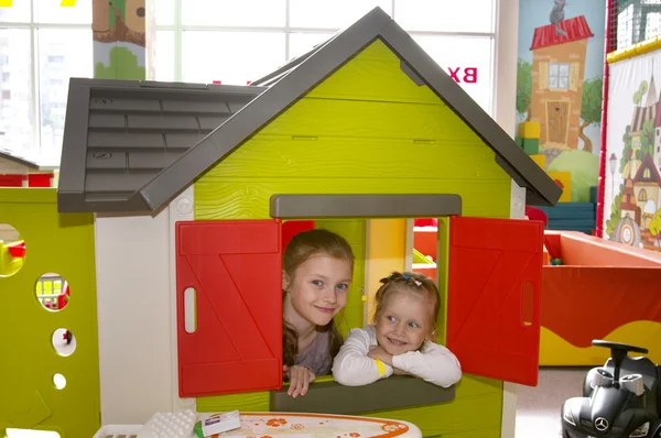 Two sisters in the playroom — Stock Photo, Image