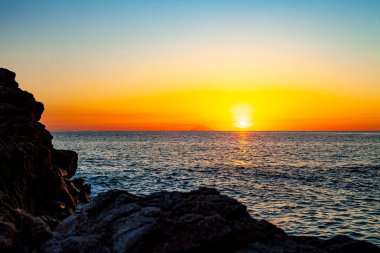 Denizin üstünde kızıl gün batımı. Güzel gün batımı. İtalya, Calabria 'da Tyrhenian Denizi gün batımı.