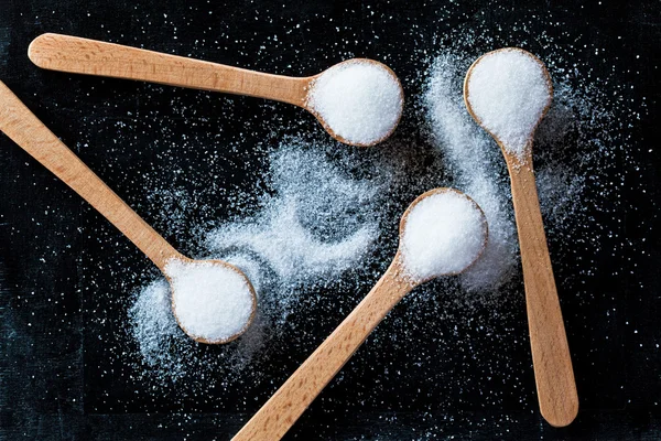 Sugar in wooden spoons — Stock Photo, Image