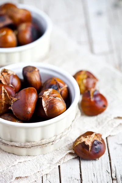 Roasted chestnuts in bowls — Stock Photo, Image