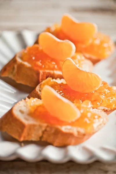 Pieces of baguette with orange marmalade — Stock Photo, Image