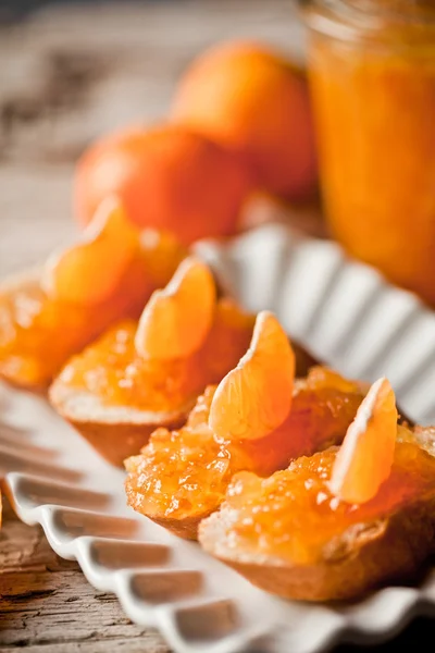 Pieces of baguette with orange marmalade — Stock Photo, Image