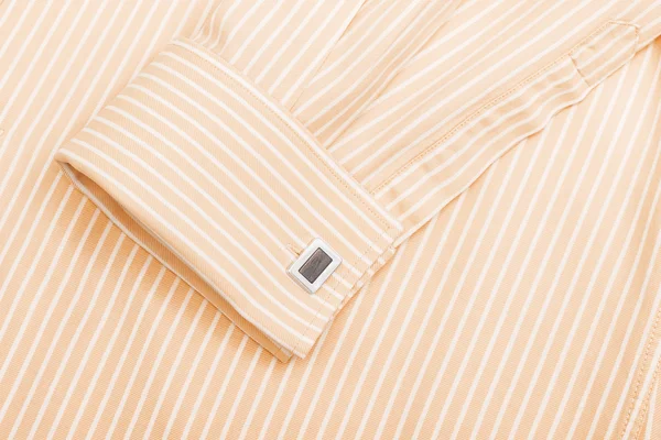 Mouw van een striped oranje shirt — Stockfoto