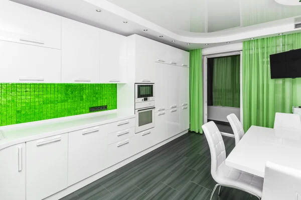 Specious modern white green interior kitchen-dining room — Stock Photo, Image