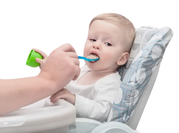 The father feeds with porridge of the one-year-old kid — Stock Photo, Image