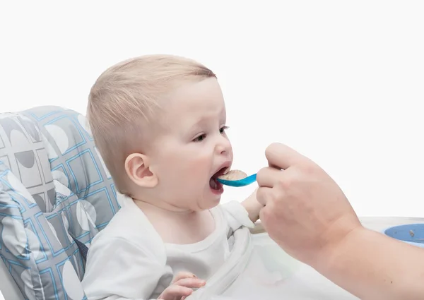 The father feeds with porridge of the one-year-old kid — Stock Photo, Image