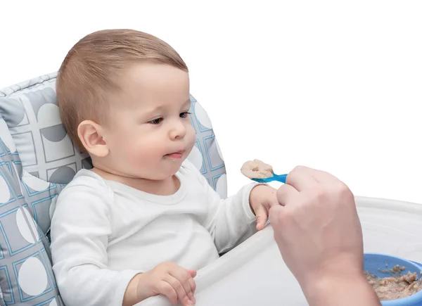 The one-year-old kid is fed with porridge — Stock Photo, Image