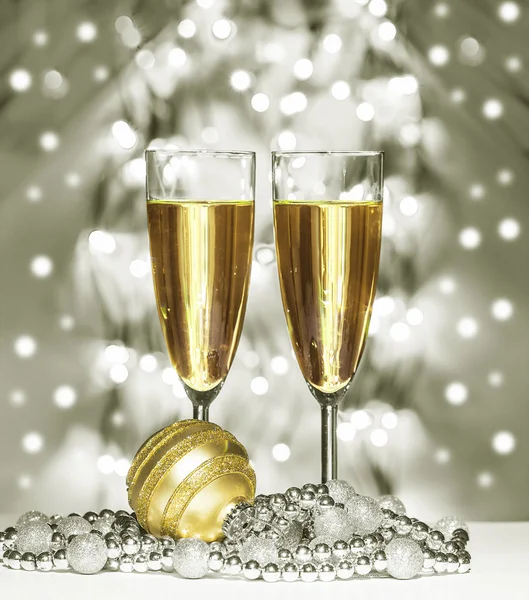 Gold christmas sphere, wine glasses