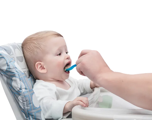 The father feeds with porridge of the one-year-old kid Stock Picture