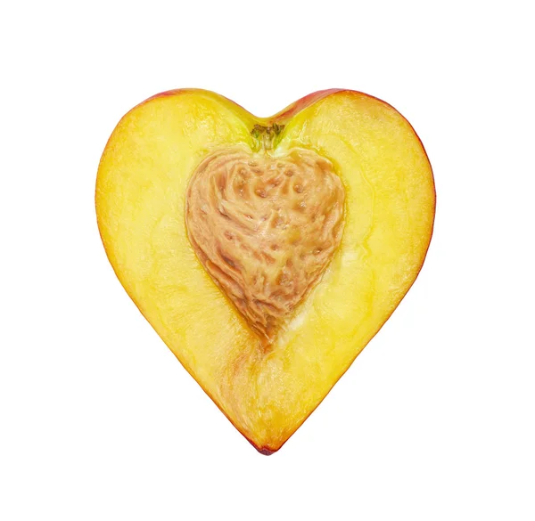 The half of the peach in the form of heart — Stock Photo, Image