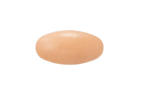 Macro orange medical pill tablet isolated on white — Stock Photo, Image