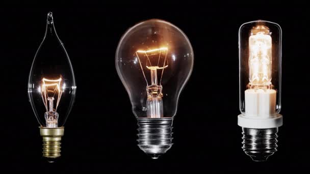 Collage aus 3 Edison-Lampen, die über schwarzem, gelooptem Video blinken — Stockvideo