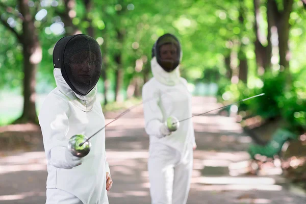 Two rapier fencers women staying in park alley getting ready for — Stock Photo, Image