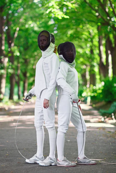 Two rapier fencers women staying in park alley getting ready for — Stock Photo, Image