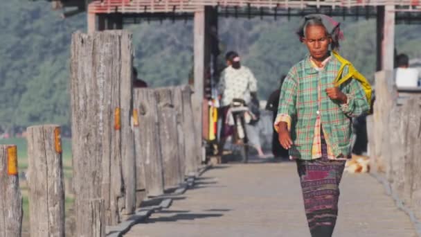 Burmese woman passing U Bein bridge — Stock Video