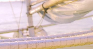 wooden sailing boat on sea shore.