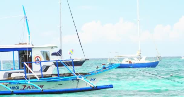 Various boats and wooden vessels floating on clear water. Water transportation — Stock Video