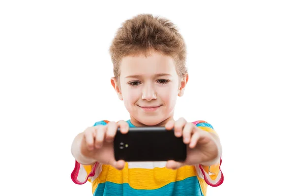 Smiling child boy holding mobile phone or smartphone taking self — Stock Photo, Image