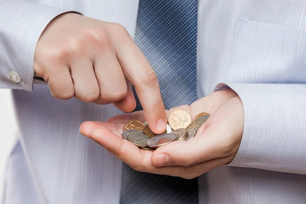 Business man hand holding coin savings counting money profit or — Stock Photo, Image