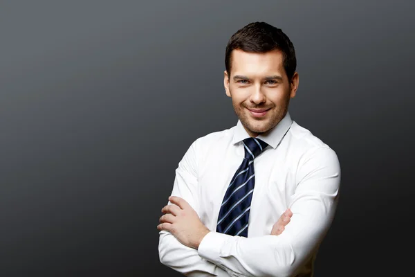 Handsome stylish businessman on grey background — Stock Photo, Image