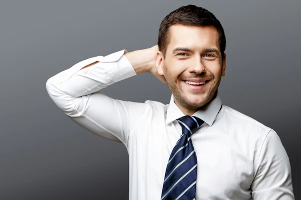 Handsome stylish businessman on grey background — Stock Photo, Image