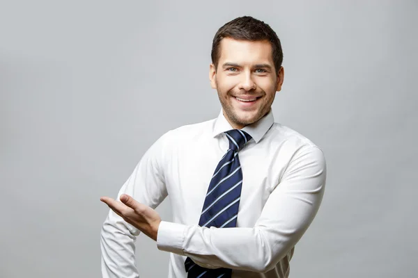 Handsome stylish businessman on grey background — Stock Photo, Image