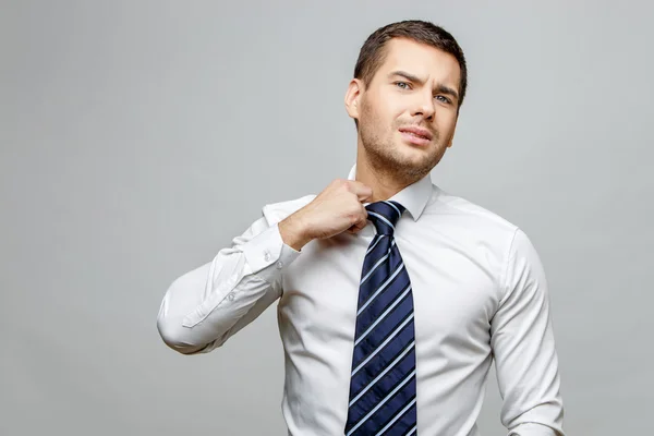 Handsome stylish businessman on grey background — Stock Photo, Image