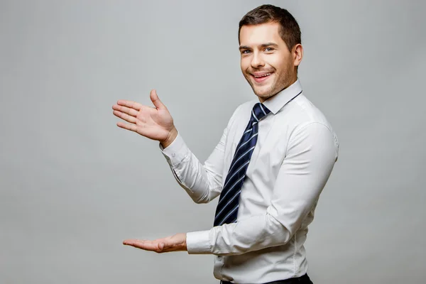 Handsome stylish businessman on grey background — Stock Photo, Image