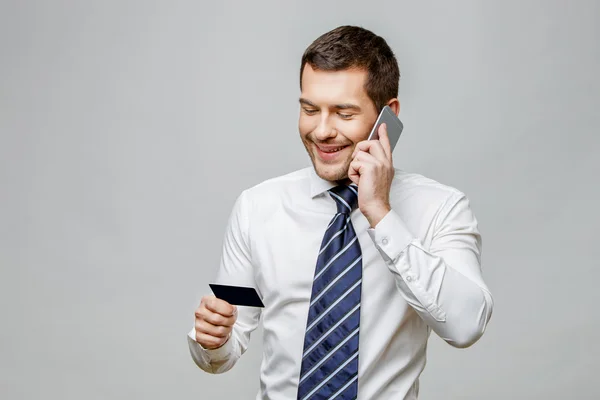 Handsome stylish businessman on grey background — Stock Photo, Image