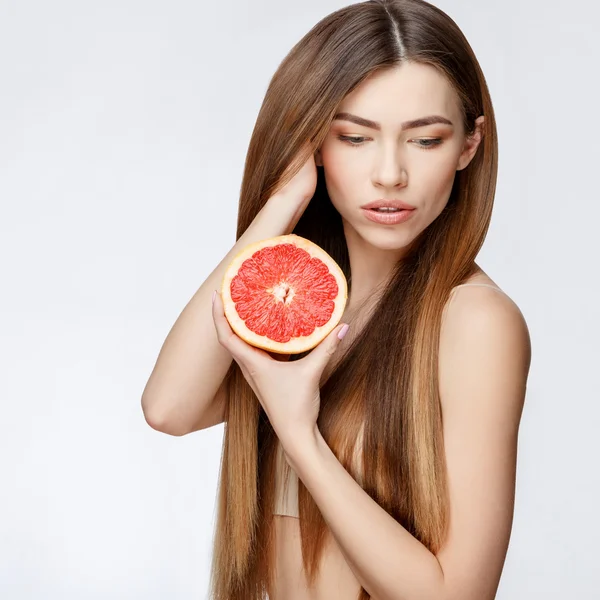 Hermosa mujer con piel limpia y fresca sosteniendo garapefruit — Foto de Stock