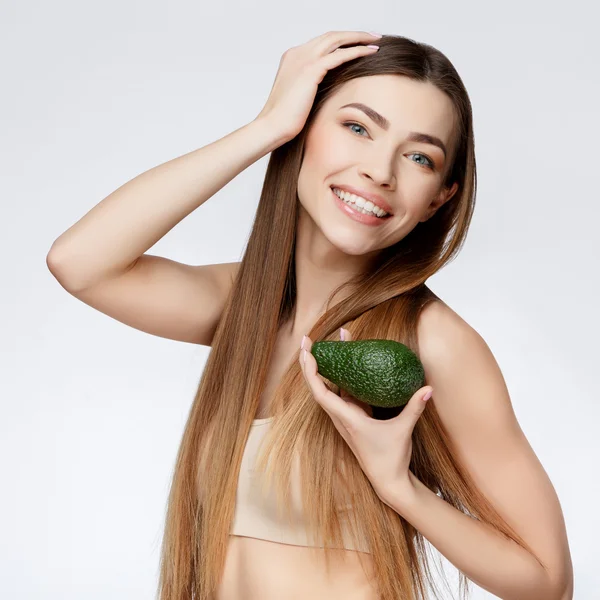 Beautiful Woman with Clean Fresh Skin holding avocado — Stock Photo, Image