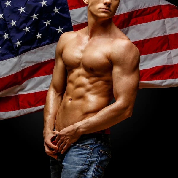 Handsome young mans torso covered with american flag