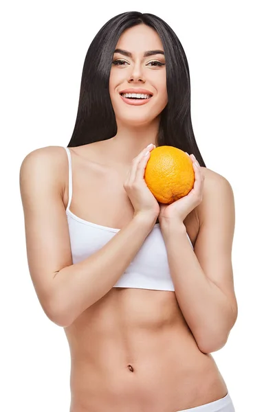 Estúdio tiro de atraente jovem mulher com corpo bonito segurando laranja isolado no branco — Fotografia de Stock