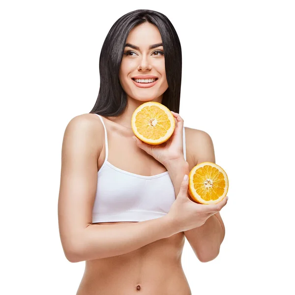 Studio shot of attractive young woman with beautiful body holding orange isolated on white — Stock Photo, Image