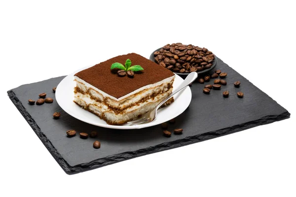 Traditional Italian Tiramisu square dessert portion on ceramic plate and coffee beans on stone serving cutting board isolated on white — Stock Photo, Image