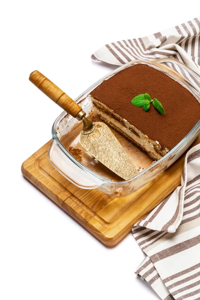 Traditional Italian Tiramisu dessert in glass baking dish on wooden cutting board isolatet on white background Stock Image
