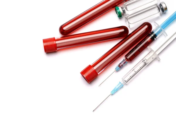 Medical ampoule vials, test tubes with blood samples and syringe on light background — Stock Photo, Image