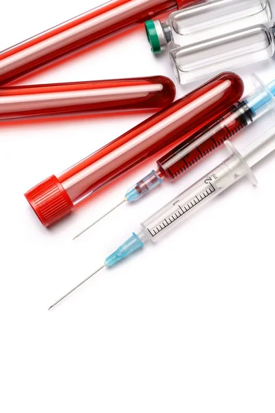 Medical ampoule vials, test tubes with blood samples and syringe on light background — Stock Photo, Image