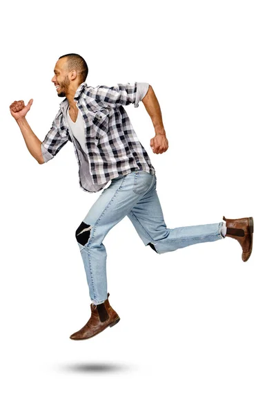 Casual african-american man jumping in studio over white background — Stok Foto