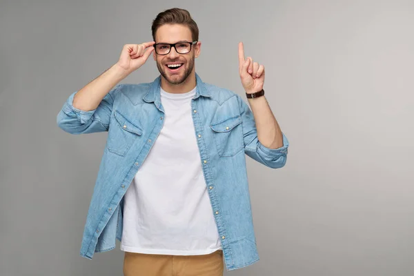 Portrait of young handsome caucasian man in jeans shirt over light background — Stock Photo, Image