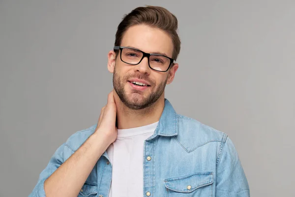 Portrait of young handsome caucasian man in jeans shirt over light background — Stock Photo, Image