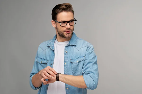 Portrait of young handsome caucasian man in jeans shirt over light background — Stock Photo, Image