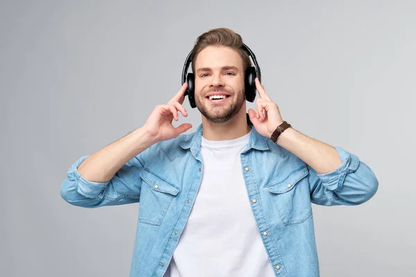 Close up retrato de jovem alegre gostando de ouvir música vestindo roupas de jeans casuais — Fotografia de Stock