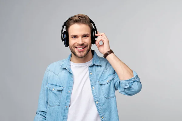 Närbild porträtt av glad ung man njuter av att lyssna på musik bär casual jeans outfit — Stockfoto